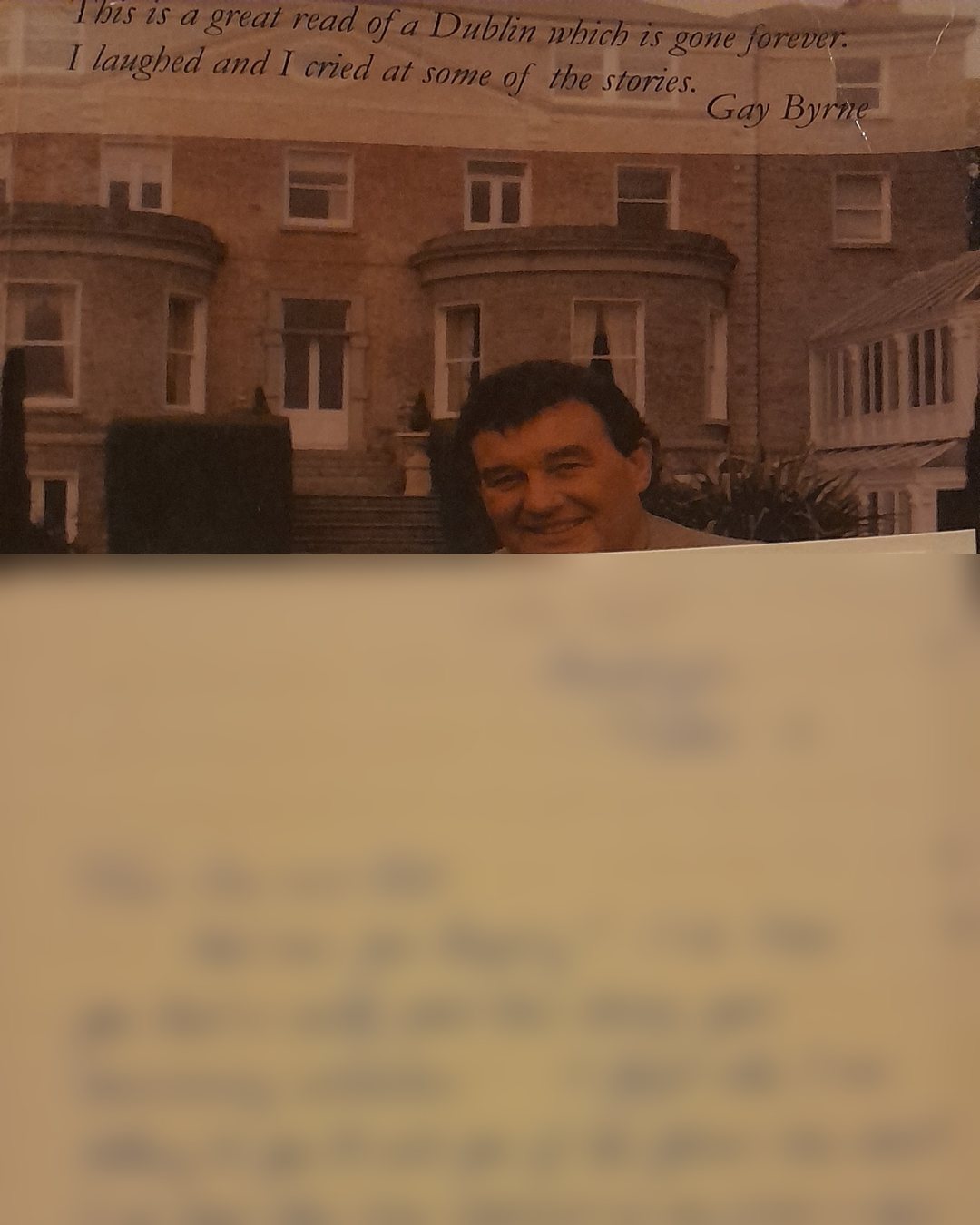 The back cover of Bill Cullen’s memoir, with a handwritten letter resting on it. The writing is blurred to protect the family.